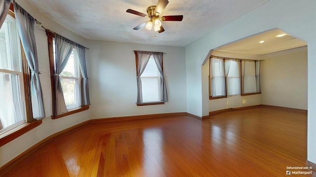 25 Garrison St, Fairhaven, MA 02719 - empty room with plenty of natural light, wood finished floors, ceiling fan, and a textured ceiling