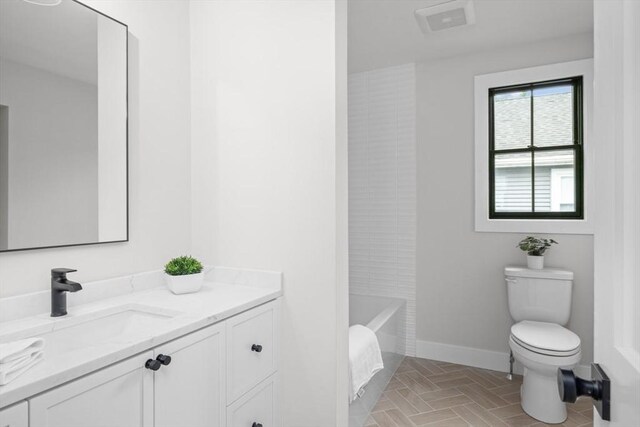 bathroom with vanity and toilet