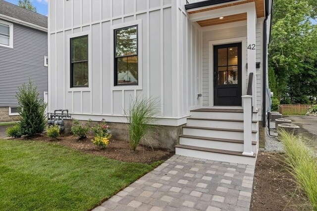 property entrance featuring french doors and a yard