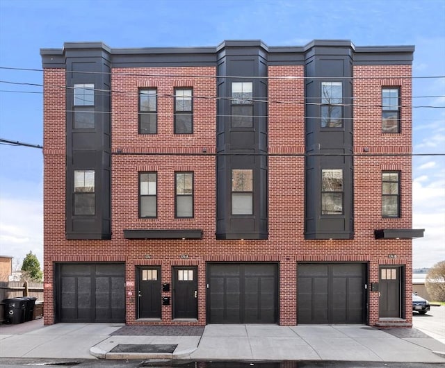 view of front of house featuring brick siding and an attached garage