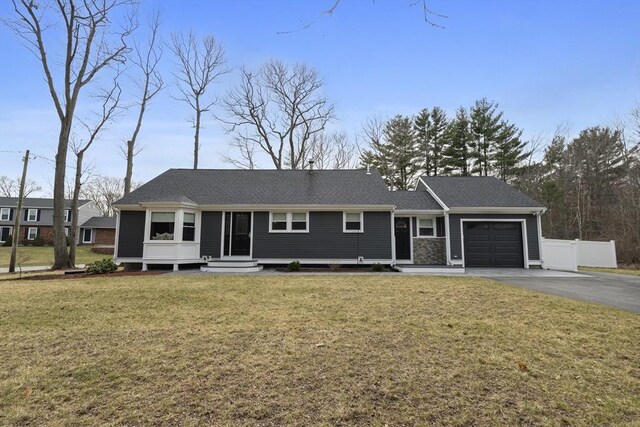 single story home with fence, aphalt driveway, entry steps, a front yard, and an attached garage