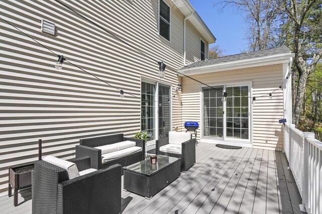 wooden terrace with an outdoor hangout area