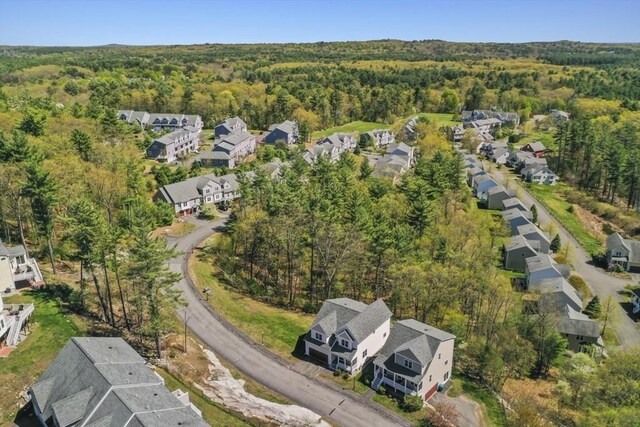drone / aerial view with a residential view and a wooded view