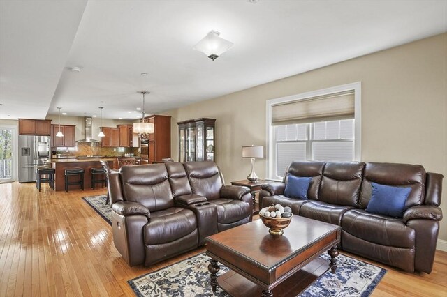 living area featuring recessed lighting and light wood-style flooring