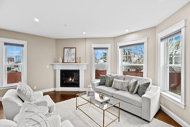 living room with light wood-type flooring and plenty of natural light