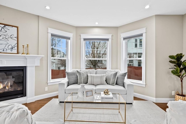 living room with plenty of natural light and dark hardwood / wood-style flooring