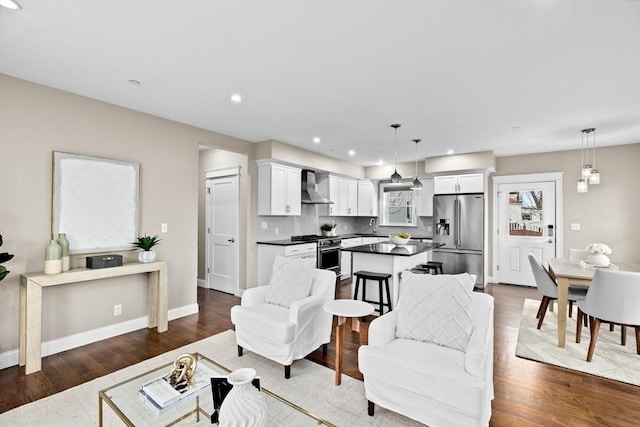 living room featuring sink and dark wood-type flooring