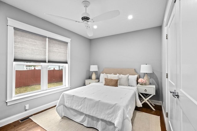 bedroom with ceiling fan and hardwood / wood-style flooring