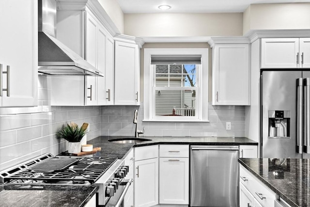 kitchen with white cabinets, stainless steel appliances, and wall chimney range hood