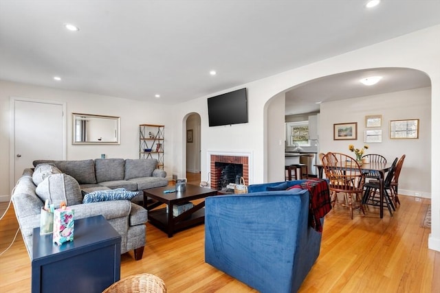 326 Austin St Unit 0, Newton, MA 02465 - living room featuring arched walkways, recessed lighting, and light wood-style floors
