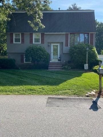 split foyer home with a front lawn