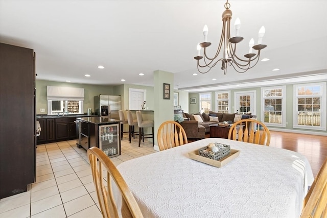 tiled dining space with beverage cooler and an inviting chandelier