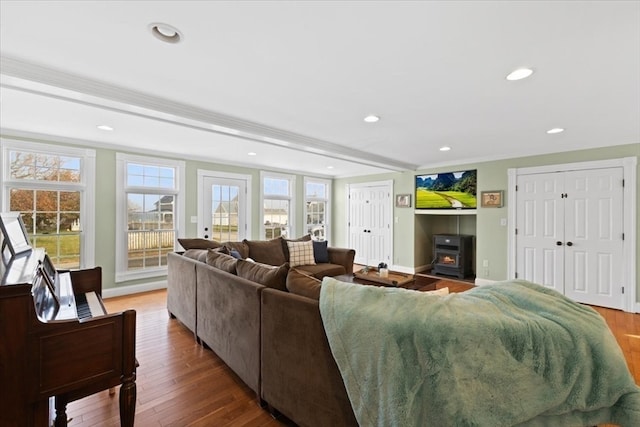 living room with wood-type flooring and a wood stove