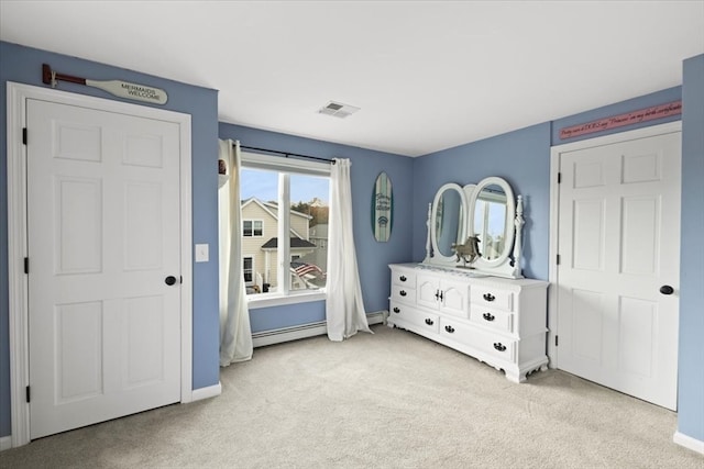 bedroom with light colored carpet and baseboard heating