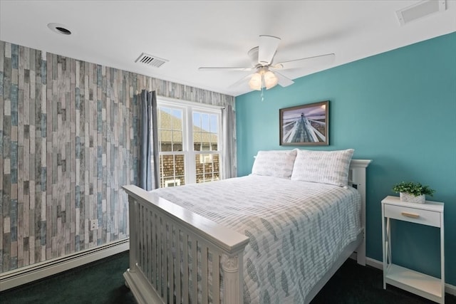 bedroom featuring dark colored carpet, a baseboard radiator, and ceiling fan