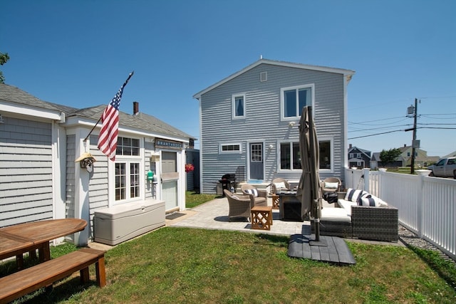 rear view of house featuring an outdoor hangout area, a patio area, and a lawn