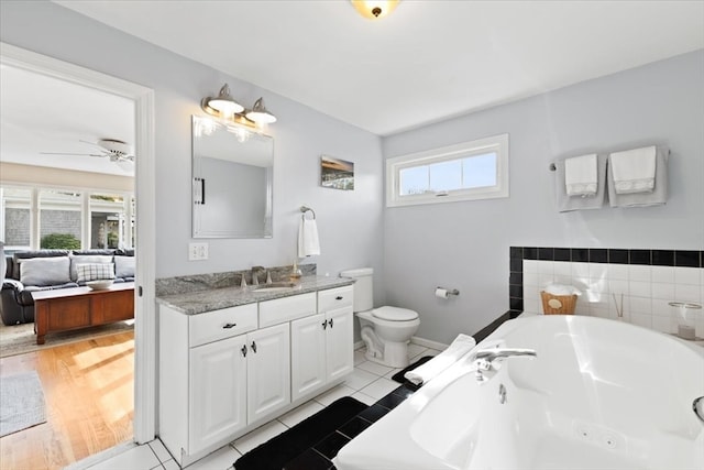 bathroom featuring a bathtub, vanity, ceiling fan, and plenty of natural light