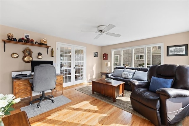 home office featuring light hardwood / wood-style floors, ceiling fan, and french doors