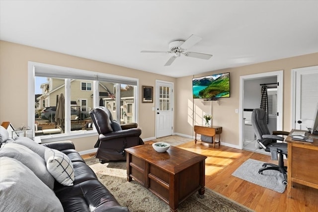 living room with light wood-type flooring and ceiling fan