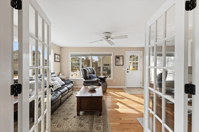 living room featuring light hardwood / wood-style floors and ceiling fan