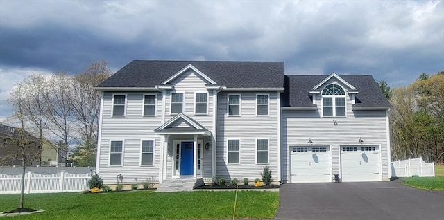 view of front of property with a garage and a front lawn