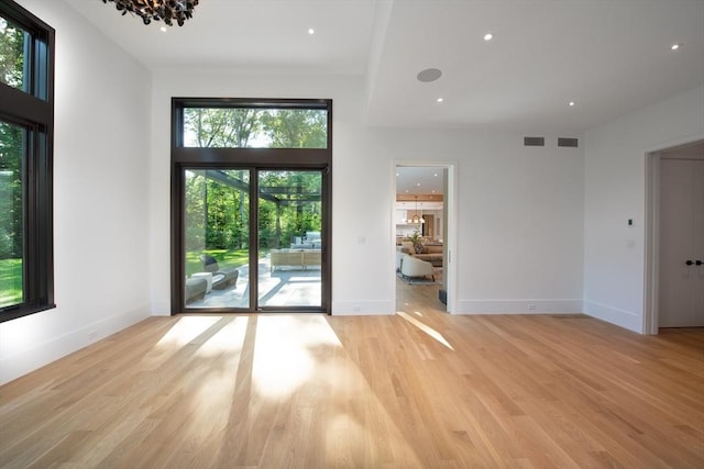 interior space with visible vents, light wood-style flooring, and baseboards