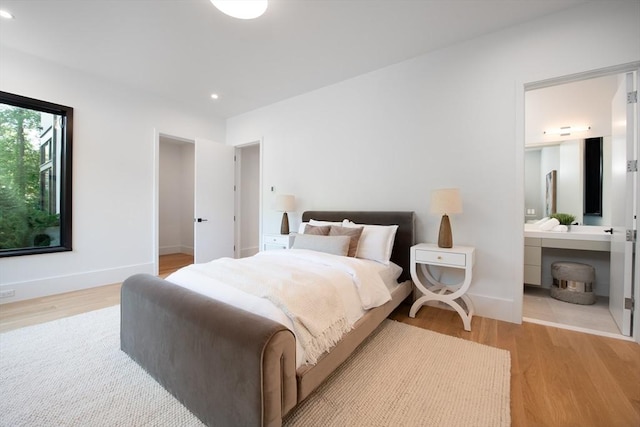 bedroom featuring light wood-style floors, recessed lighting, and baseboards