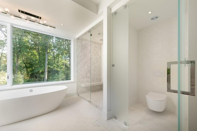 bathroom featuring toilet, recessed lighting, marble finish floor, a soaking tub, and a stall shower