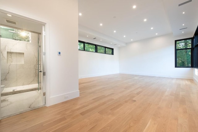 empty room featuring baseboards, recessed lighting, visible vents, and light wood-style floors