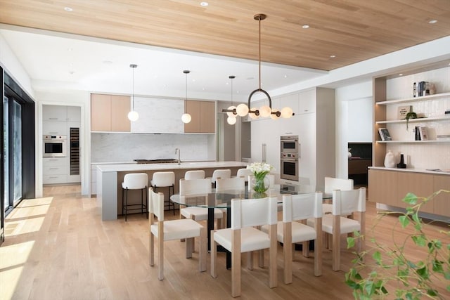 dining area featuring light wood-type flooring, wooden ceiling, recessed lighting, and an inviting chandelier