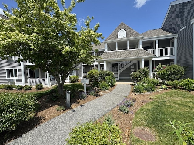 101 Fletcher Unit K, Brewster, MA 02631 - view of front of property with covered porch, stairway, and roof with shingles