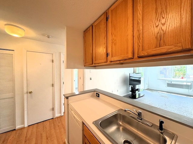 101 Fletcher Unit K, Brewster, MA 02631 - kitchen with a sink, brown cabinets, light wood-style floors, dishwasher, and light countertops