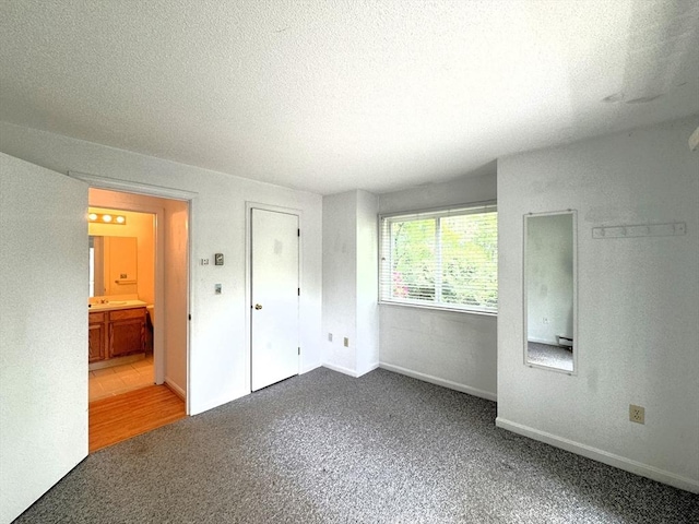 101 Fletcher Unit K, Brewster, MA 02631 - unfurnished bedroom with carpet flooring, a textured ceiling, and baseboards