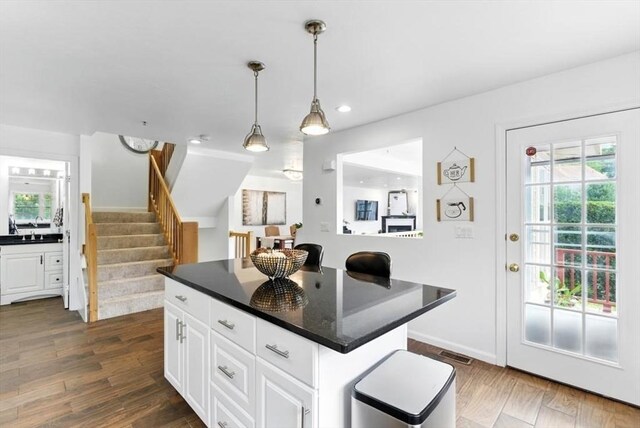 12 Paul Revere Path Unit 12, Hopkinton, MA 01748 - kitchen with dark countertops, white cabinetry, healthy amount of natural light, hanging light fixtures, and recessed lighting