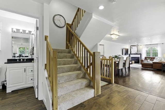 12 Paul Revere Path Unit 12, Hopkinton, MA 01748 - staircase featuring healthy amount of natural light, wood finished floors, recessed lighting, and a fireplace