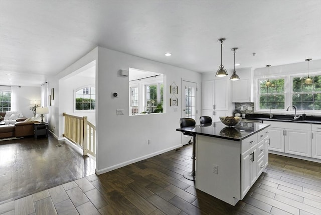 12 Paul Revere Path Unit 12, Hopkinton, MA 01748 - kitchen with dark countertops, white cabinets, a kitchen island, dark wood-style flooring, and recessed lighting