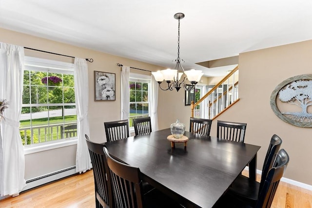 48 Logans Run, Attleboro, MA 02703 - dining area with a chandelier, light wood finished floors, a baseboard heating unit, and stairway