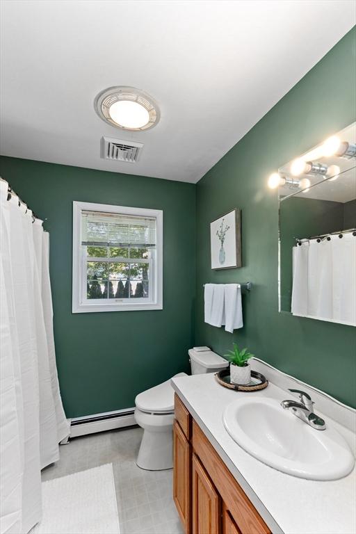 48 Logans Run, Attleboro, MA 02703 - full bath featuring a baseboard heating unit, vanity, toilet, and a shower with curtain