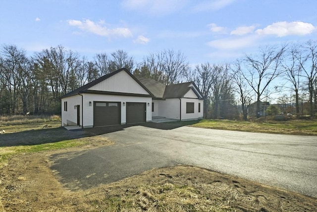 exterior space featuring a garage and a yard