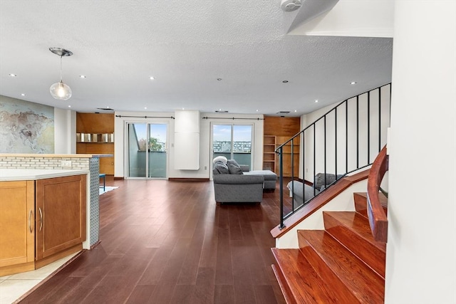 154 Lynnway Unit 509, Lynn, MA 01902 - living room with wood finished floors, recessed lighting, stairway, and a textured ceiling