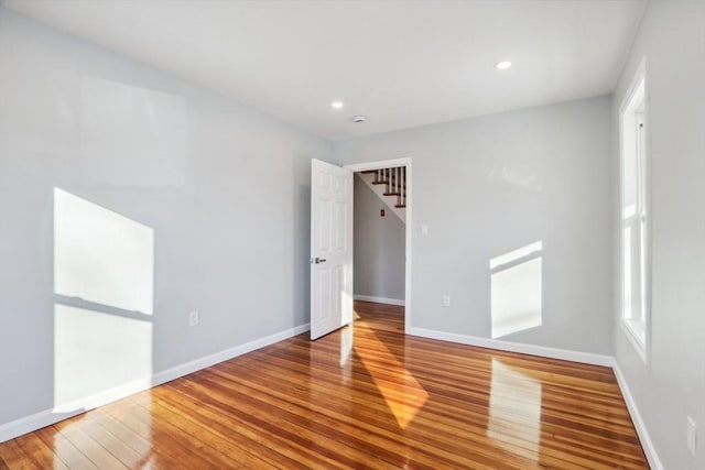 spare room featuring wood-type flooring