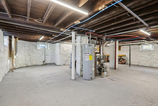 basement featuring water heater and a wealth of natural light