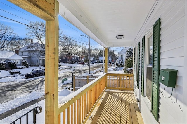 view of snow covered back of property