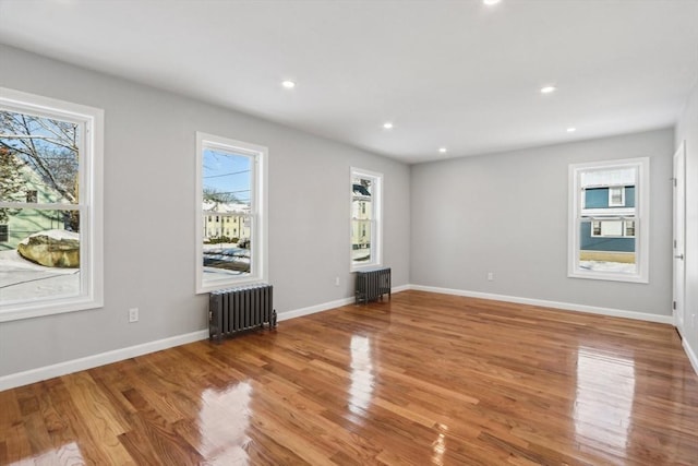 interior space with radiator heating unit and light wood-type flooring