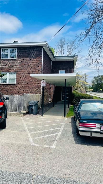 view of vehicle parking featuring fence