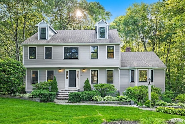 39 Blueberry Ln, Hopkinton, MA 01748 - view of front facade featuring a front lawn, roof with shingles, and a chimney