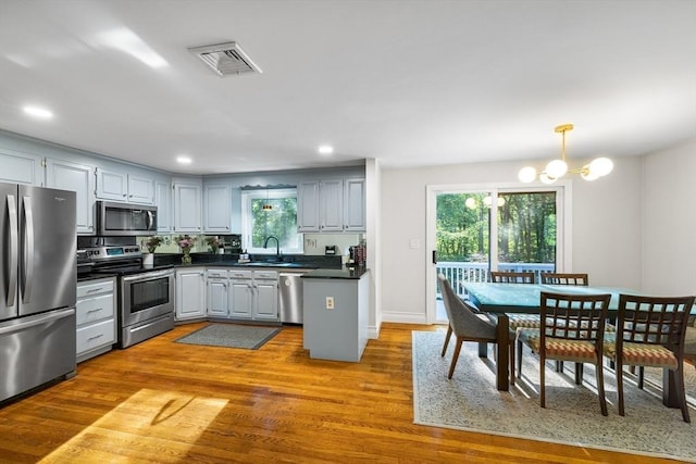 39 Blueberry Ln, Hopkinton, MA 01748 - kitchen with stainless steel appliances, dark countertops, healthy amount of natural light, dark wood finished floors, and recessed lighting