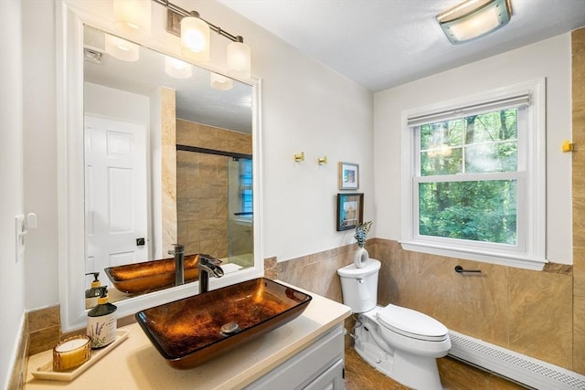 39 Blueberry Ln, Hopkinton, MA 01748 - full bath featuring a baseboard radiator, a tile shower, vanity, tile walls, and a wainscoted wall