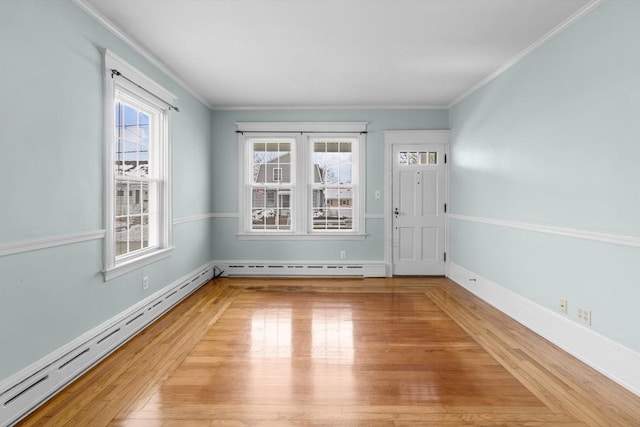 foyer with hardwood / wood-style flooring, crown molding, and a baseboard heating unit