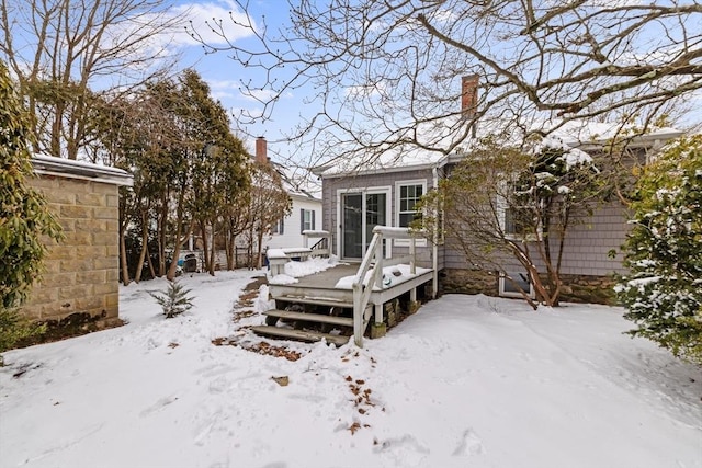 snow covered property featuring a wooden deck